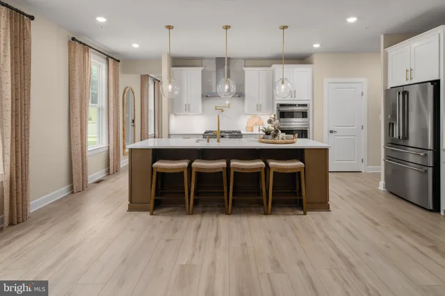 a large kitchen with a table and chairs