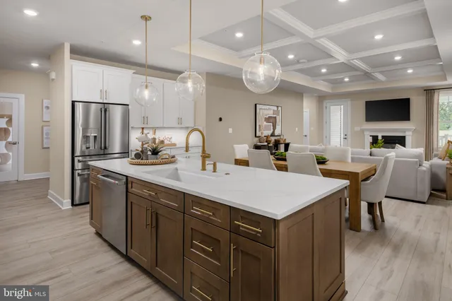 an open kitchen with a sink a counter space stainless steel appliances and cabinets
