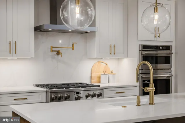 a stove top oven sitting inside of a kitchen
