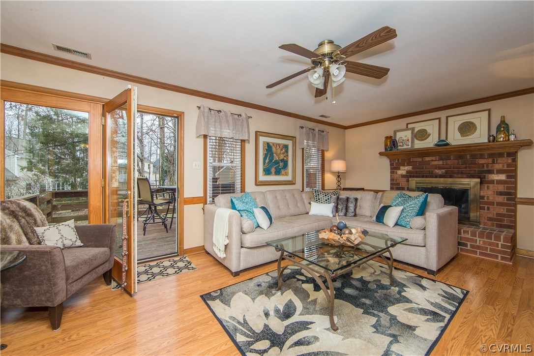 4907 Cedar Cliff Road Chester, VA 23831 - Photo 17 of 36 a living room with furniture a fireplace and a floor to ceiling window
