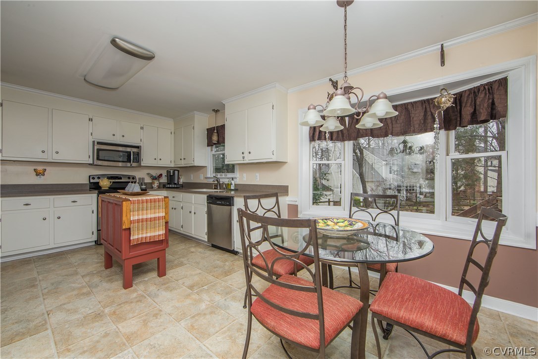 4907 Cedar Cliff Road Chester, VA 23831 - Photo 20 of 36 a kitchen with a dining table chairs and stove