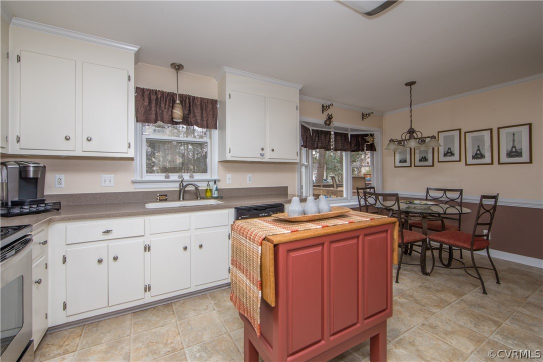 4907 Cedar Cliff Road Chester, VA 23831 - Photo 21 of 36 a kitchen with stainless steel appliances granite countertop a stove a sink and white cabinets