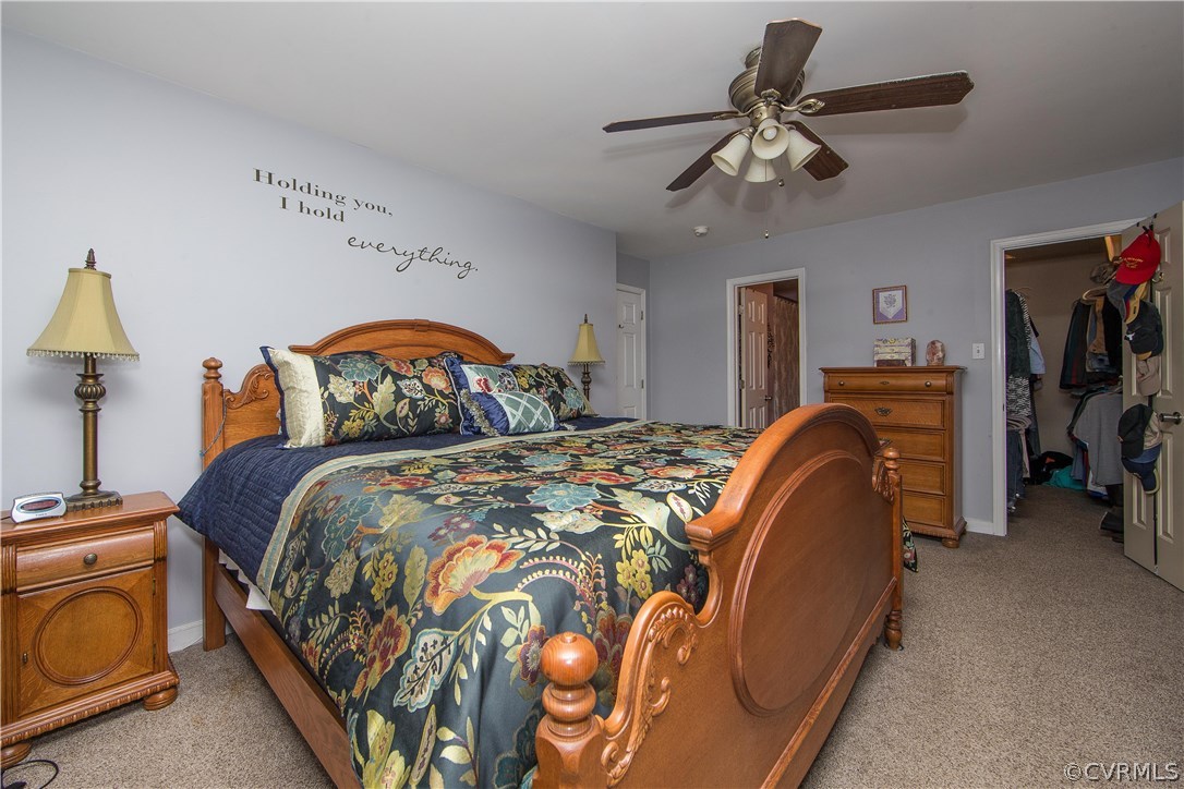4907 Cedar Cliff Road Chester, VA 23831 - Photo 24 of 36 a bedroom with bed and a chandelier