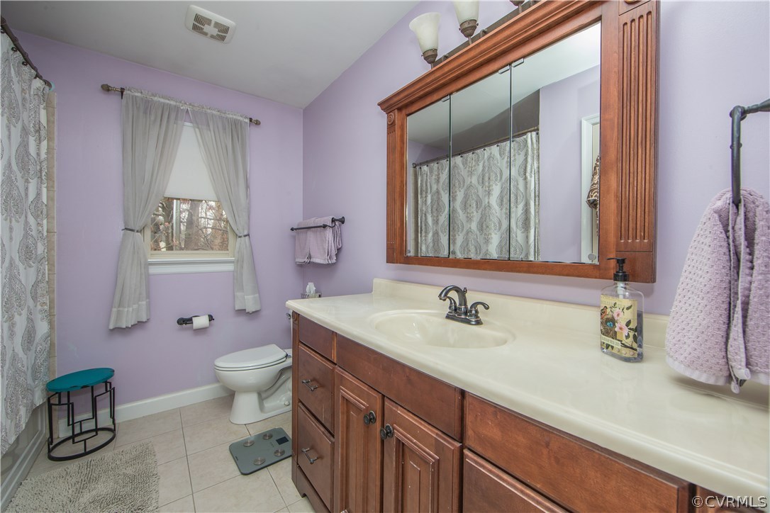 4907 Cedar Cliff Road Chester, VA 23831 - Photo 25 of 36 a bathroom with a granite countertop toilet sink and mirror
