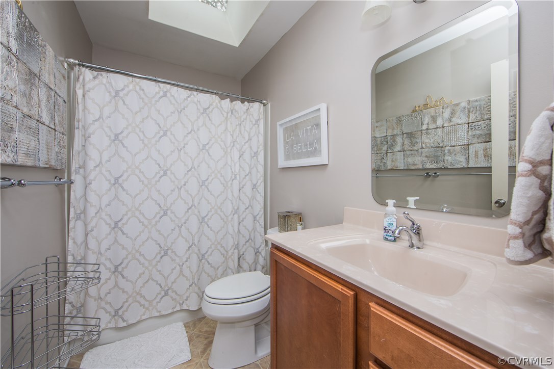 4907 Cedar Cliff Road Chester, VA 23831 - Photo 28 of 36 a bathroom with a sink a toilet and shower curtain