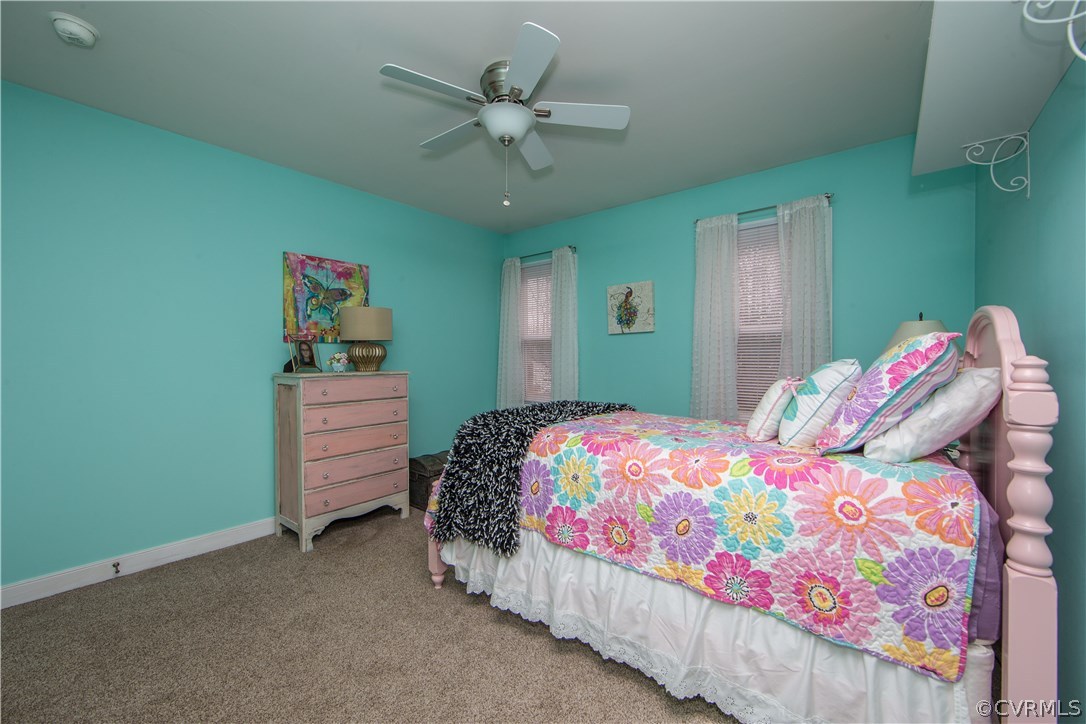4907 Cedar Cliff Road Chester, VA 23831 - Photo 31 of 36 a bedroom with a bed and a chandelier
