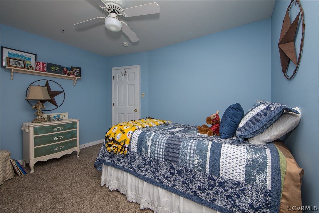 4907 Cedar Cliff Road Chester, VA 23831 - Photo 33 of 36 a bedroom with bed and a chandelier