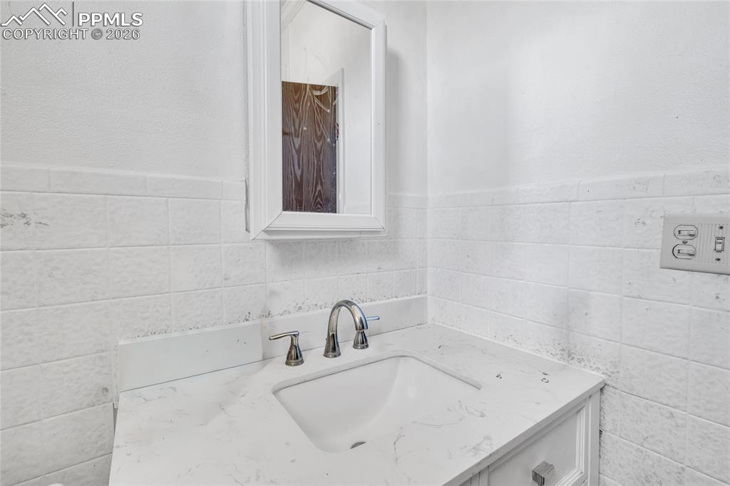 68300 Highway 50 Fowler, CO 81039 - Photo 12 of 49 Bathroom with vanity and tile walls
