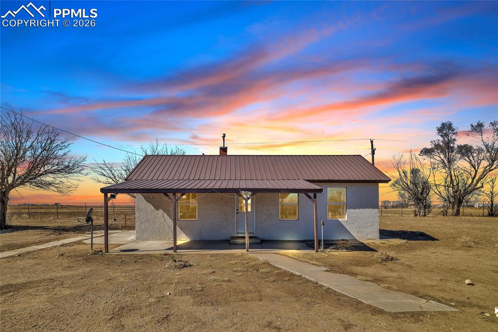 68300 Highway 50 Fowler, CO 81039 - Photo 2 of 47 View of front of house featuring a metal roof, stucco siding, and a chimney