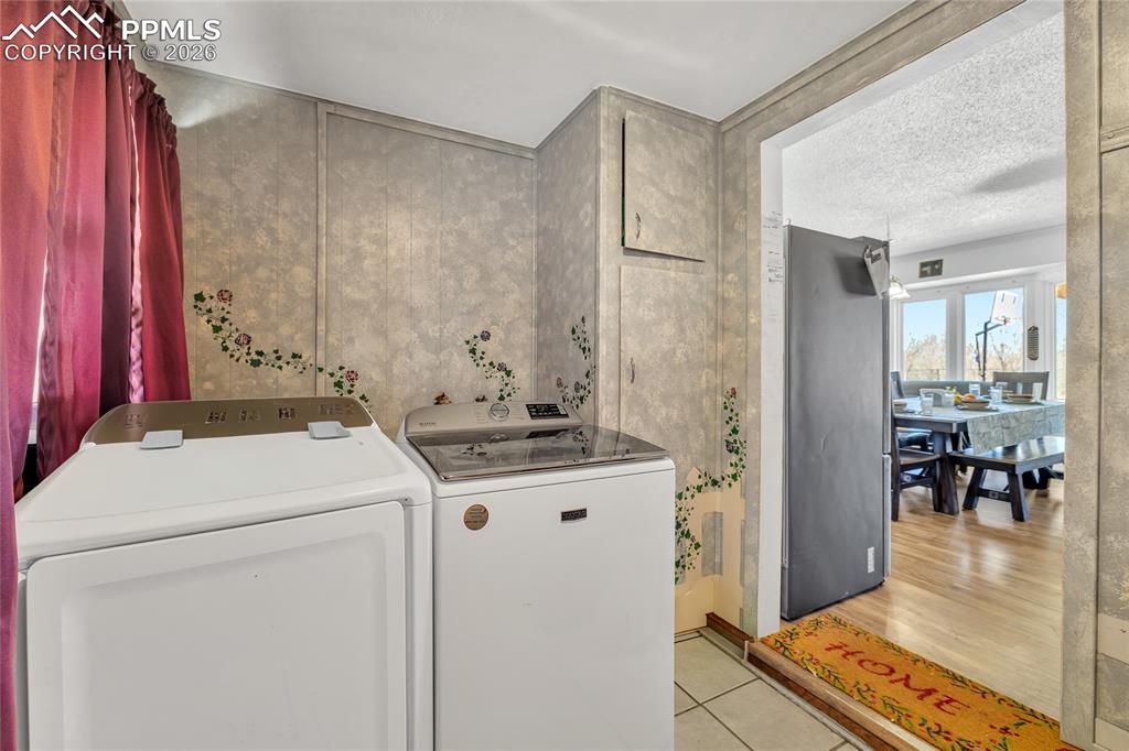 68300 Highway 50 Fowler, CO 81039 - Photo 21 of 49 Laundry room with light tile patterned floors and separate washer and dryer