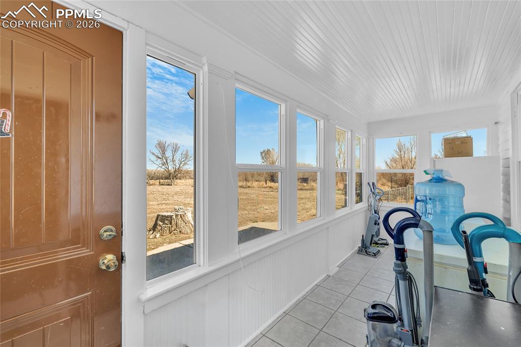 68300 Highway 50 Fowler, CO 81039 - Photo 26 of 47 Sunroom / solarium with tile patterned floors and wooden ceiling