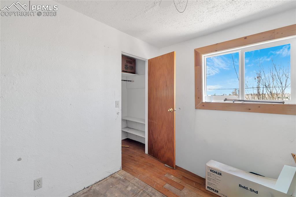 68300 Highway 50 Fowler, CO 81039 - Photo 31 of 47 ADU Unfurnished bedroom featuring light wood finished floors, a textured ceiling, and heating unit