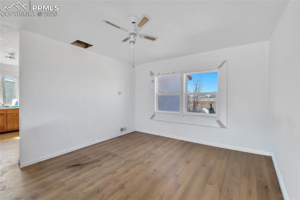 68300 Highway 50 Fowler, CO 81039 - Photo 37 of 47 ADU Empty room with wood finished floors and ceiling fan