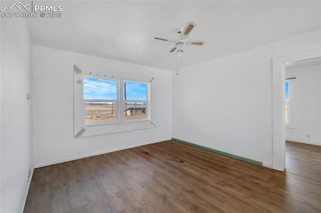 68300 Highway 50 Fowler, CO 81039 - Photo 40 of 49 ADU Unfurnished room with dark wood-style flooring and ceiling fan
