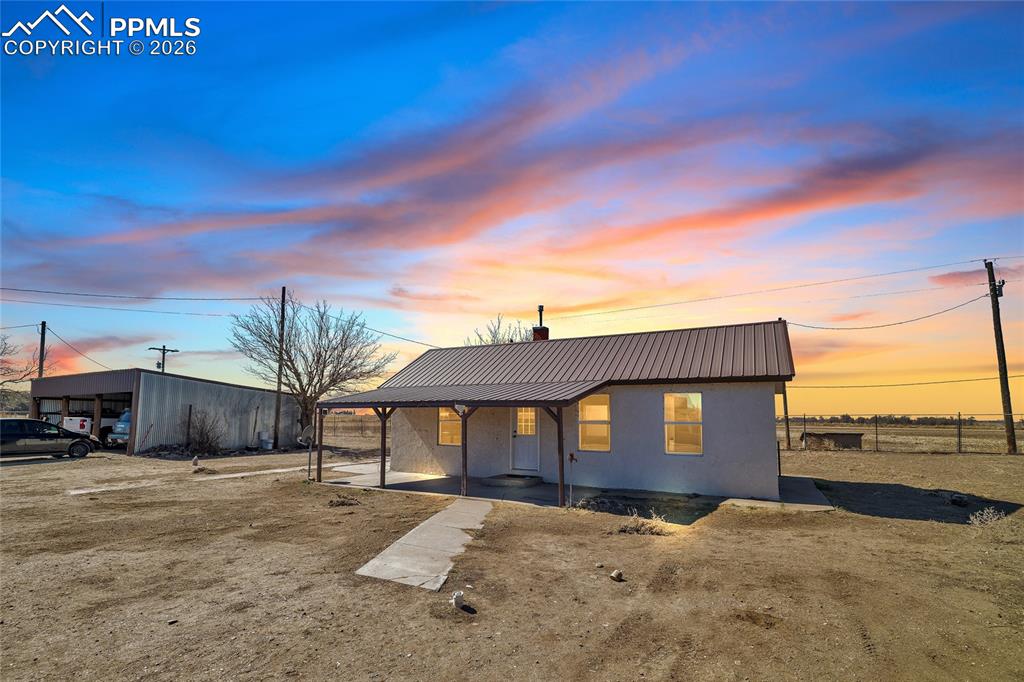 68300 Highway 50 Fowler, CO 81039 - Photo 4 of 47 View of front of property with a metal roof, covered porch, and stucco siding