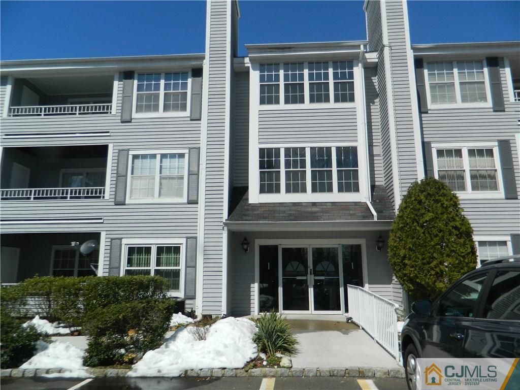 110 Raintree Court, Unit 110 Helmetta, NJ 08828 - Photo 1 of 5 a view of a building with a window and balcony