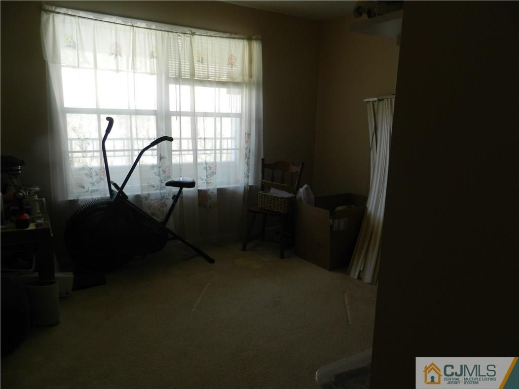 110 Raintree Court, Unit 110 Helmetta, NJ 08828 - Photo 4 of 5 a room with gym equipment and a window