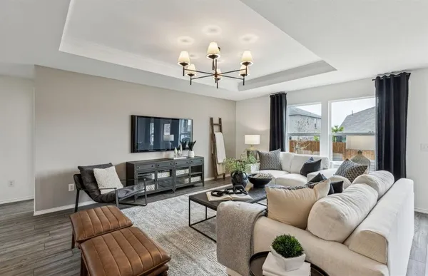 a living room with furniture and a chandelier
