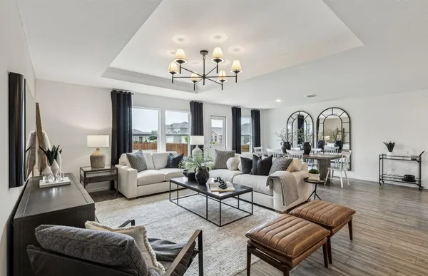 a living room with furniture chandelier and a chandelier