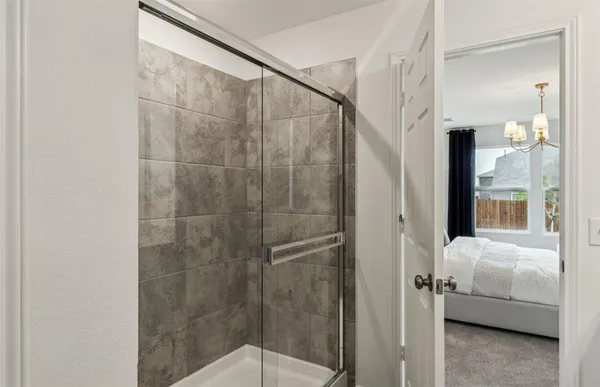 a bathroom with a shower and a sink