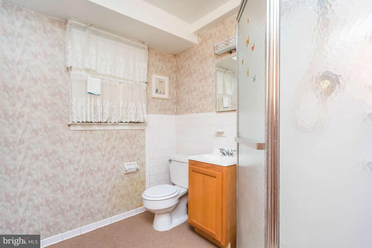 7722 Trappe Road Dundalk, MD 21222 - Photo 15 of 27 a bathroom with a toilet a sink and shower