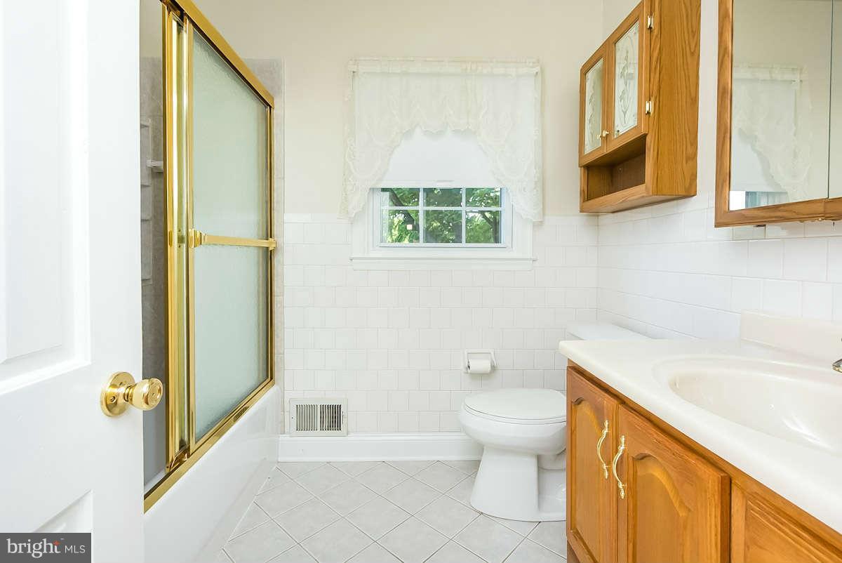 7722 Trappe Road Dundalk, MD 21222 - Photo 19 of 27 a bathroom with a sink a toilet and a bathtub