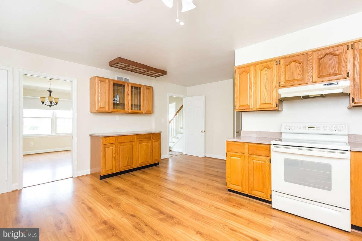 7722 Trappe Road Dundalk, MD 21222 - Photo 8 of 27 a kitchen with stainless steel appliances granite countertop a stove a sink and a refrigerator