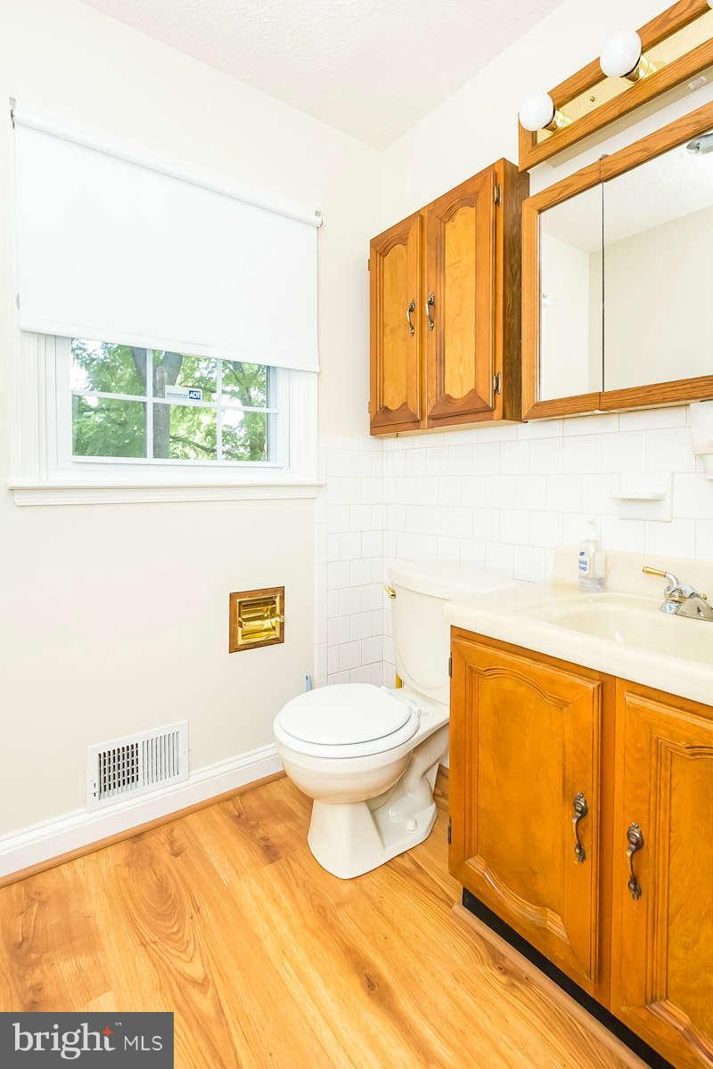 7722 Trappe Road Dundalk, MD 21222 - Photo 9 of 27 a bathroom with a toilet sink and mirror
