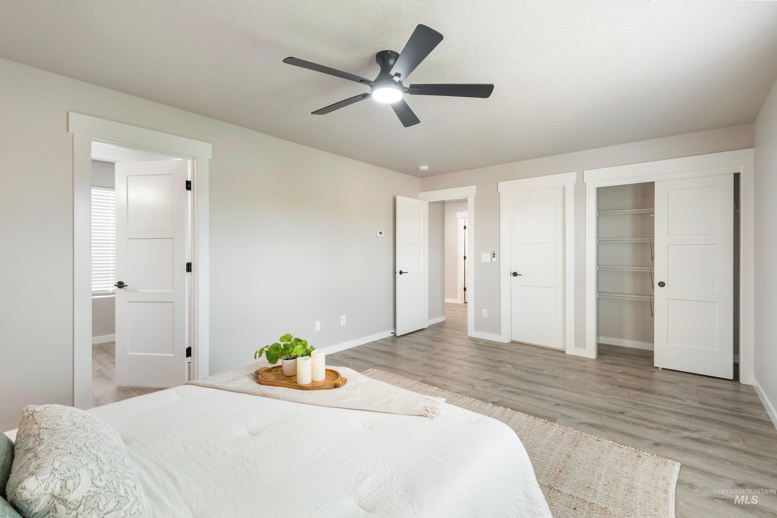 16759 Abram Avenue Caldwell, ID 83607 - Photo 20 of 33 Spacious room featuring wood-finish flooring, a contemporary ceiling fan, and white trim throughout