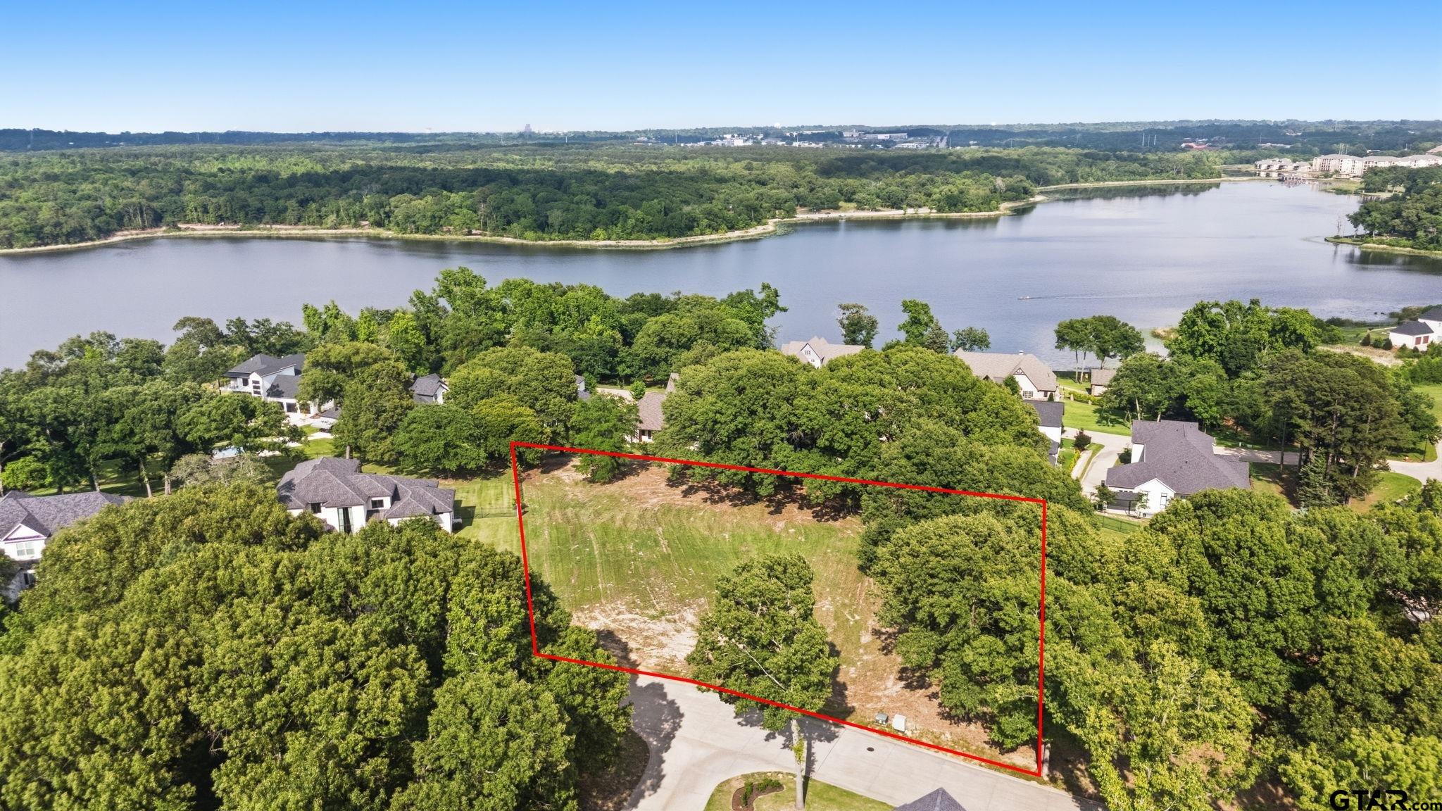 2473 Wellington Trace Tyler, TX 75709 - Photo 1 of 18 a view of a lake with a city