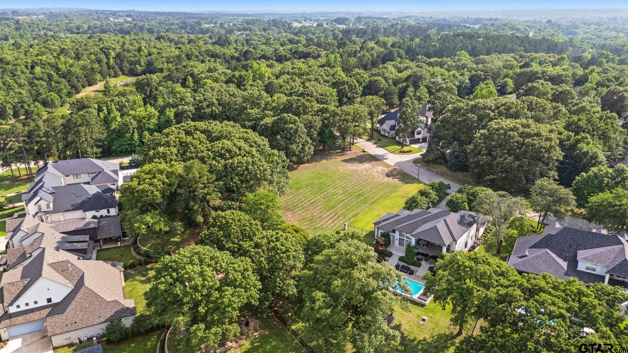 2473 Wellington Trace Tyler, TX 75709 - Photo 14 of 18 an aerial view of residential houses with outdoor space and trees