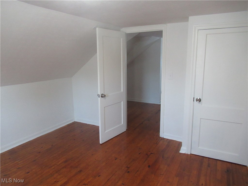 1397 Sunset Road Cleveland, OH 44124 - Photo 24 of 32 Additional living space featuring dark wood finished floors, vaulted ceiling, and baseboards