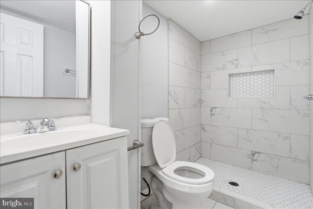 1231 North Potomac Street Baltimore, MD 21213 - Photo 22 of 25 a bathroom with a sink a toilet and a mirror