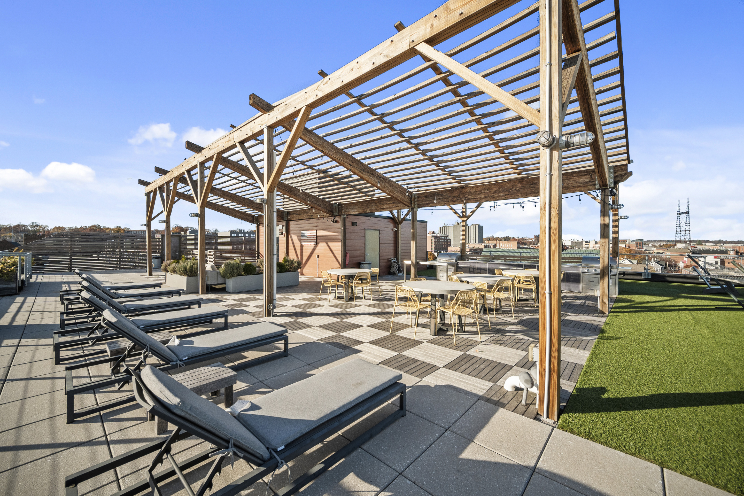 19 Day Street, Unit 409 Norwalk, CT 06854 - Photo 1 of 1 a view of a patio with table and chairs with wooden floor and fence