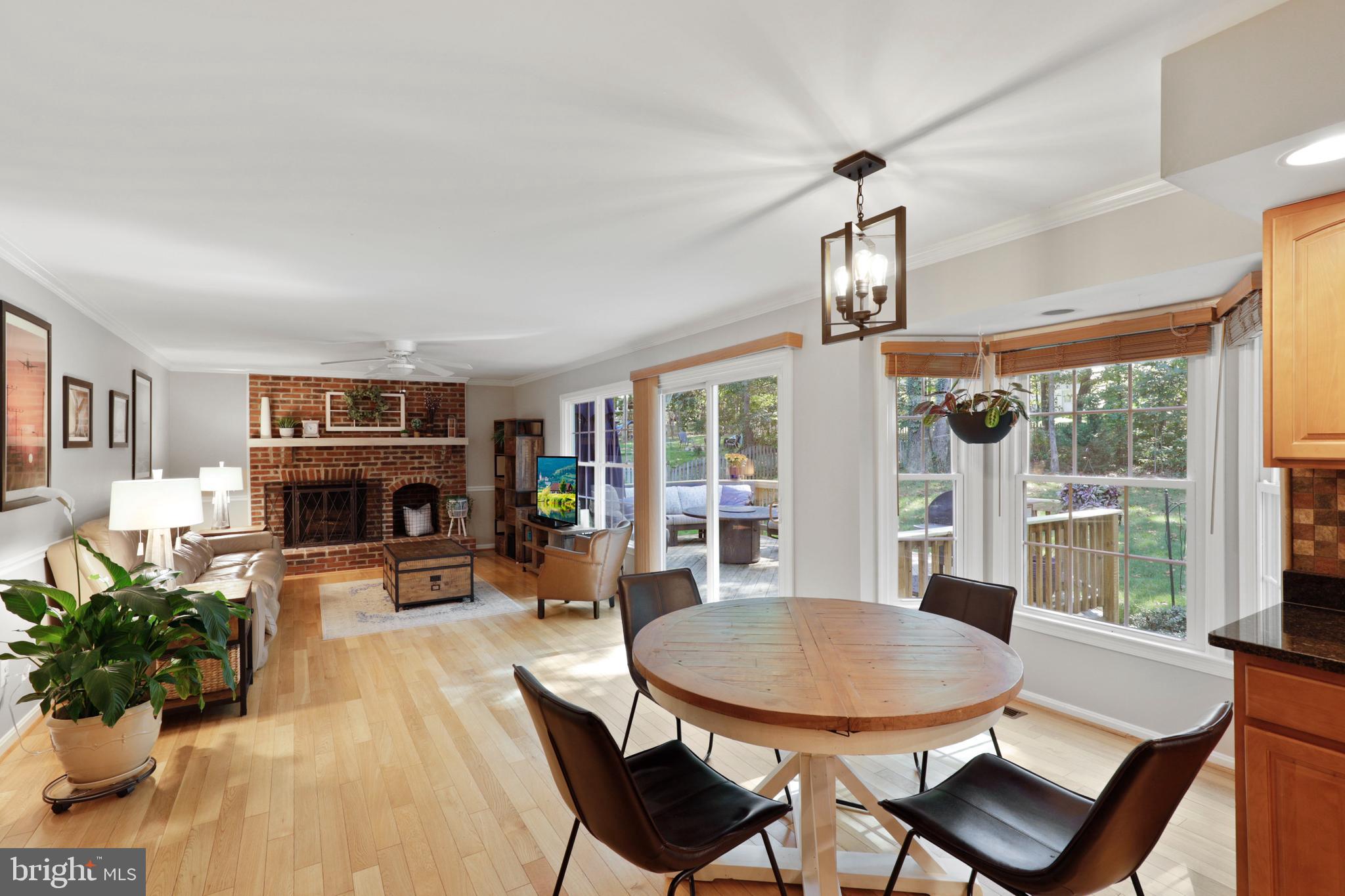 Light filled living room with fireplace and wood b