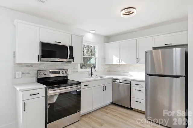 a kitchen with a refrigerator stove and sink