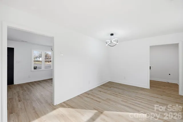 a view of a room with wooden floor