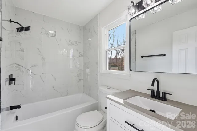 a bathroom with a sink toilet tub and shower