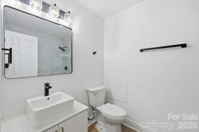 a bathroom with a sink mirror and toilet