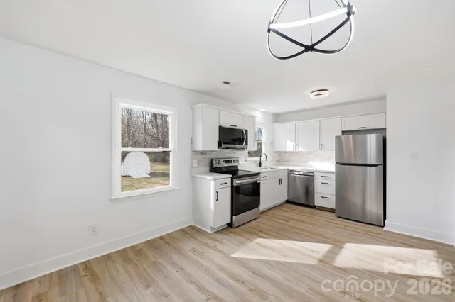 a view of a kitchen with microwave and cabinets