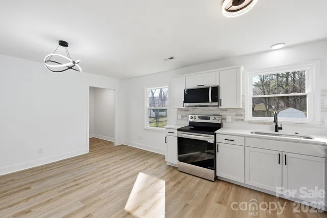 a kitchen with a sink stove and microwave