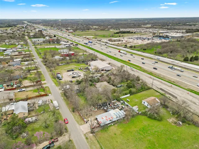 an aerial view of a house with a yard and a outdoor space