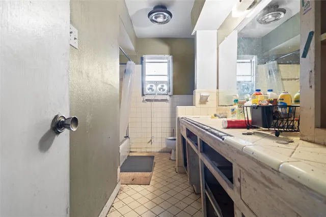 a kitchen with granite countertop a sink stainless steel appliances and cabinets