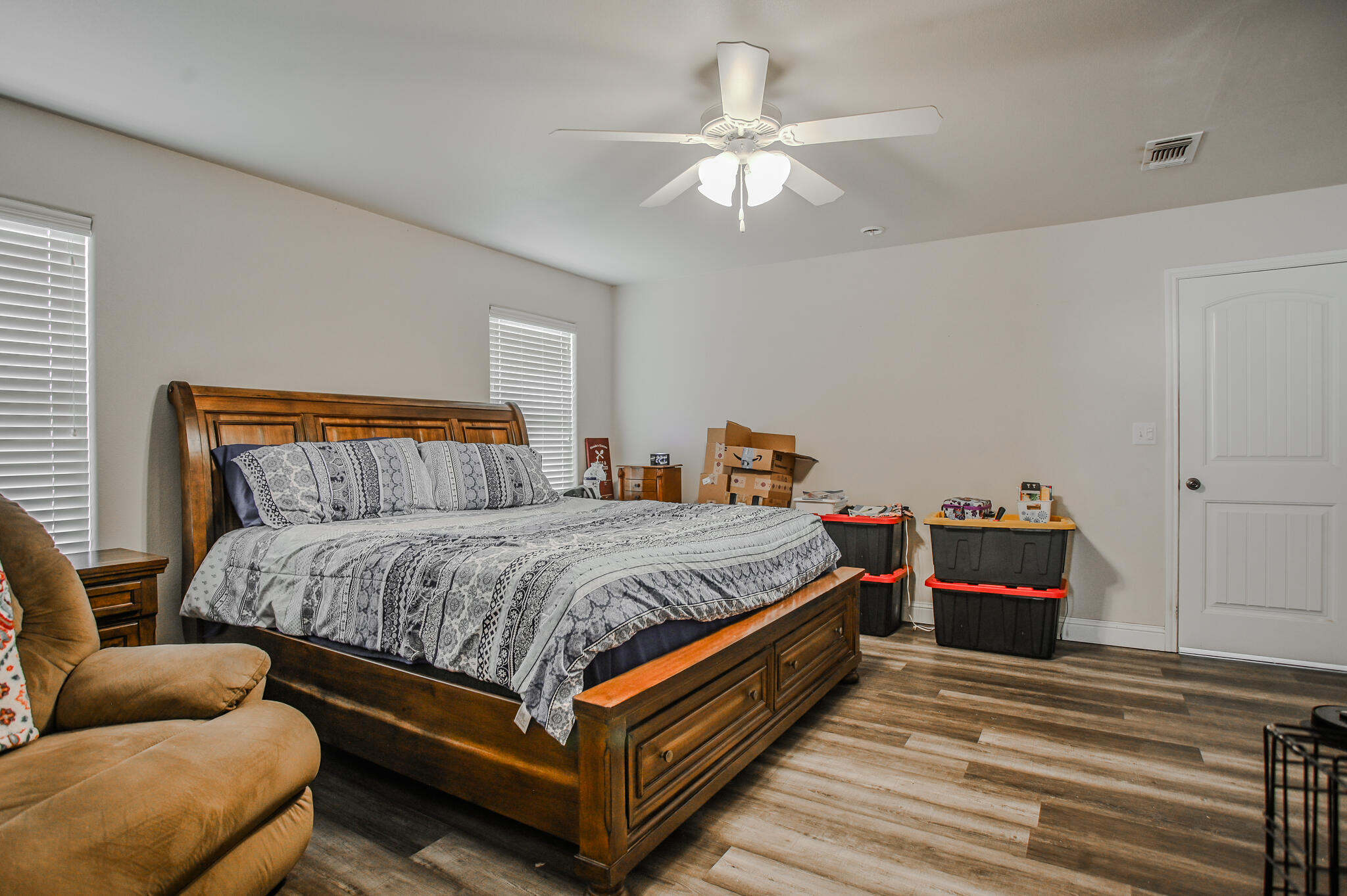 3637 Ridgely Avenue Lubbock, TX 79407 - Photo 17 of 37 a bedroom with a bed and a chandelier
