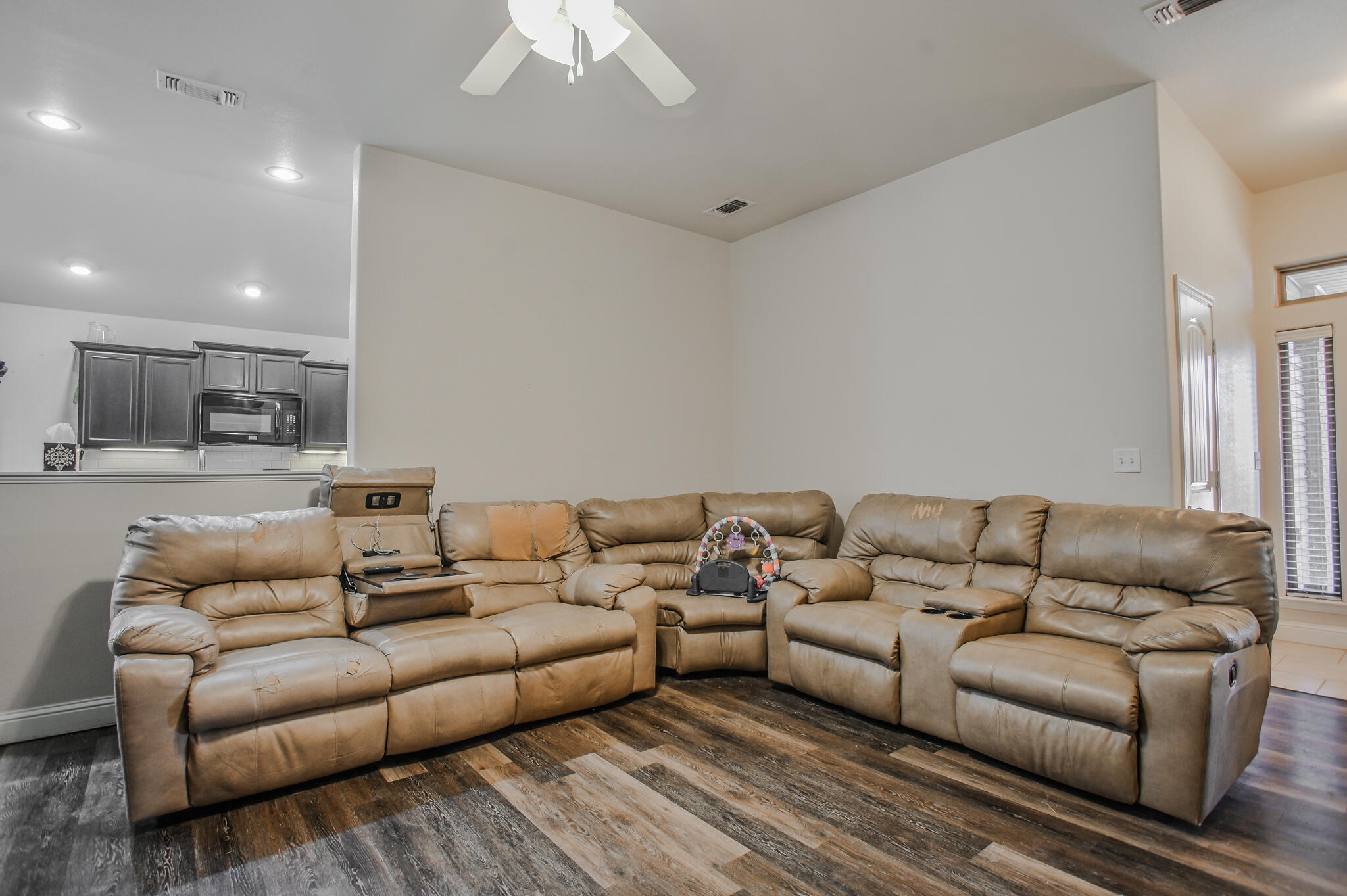 3637 Ridgely Avenue Lubbock, TX 79407 - Photo 5 of 37 a living room with furniture white walls and a view of kitchen