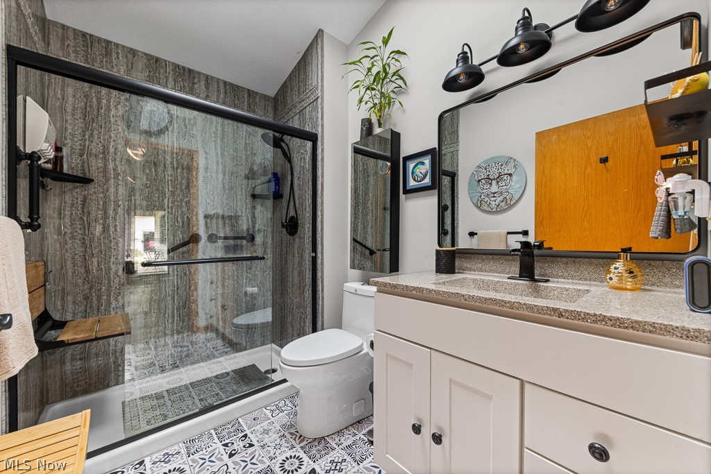 808 Ryan Road, Unit 14 Medina, OH 44256 - Photo 26 of 40 Bathroom featuring a walk-in shower with glass enclosure, wood-finish wall panels, and a built-in folding bench