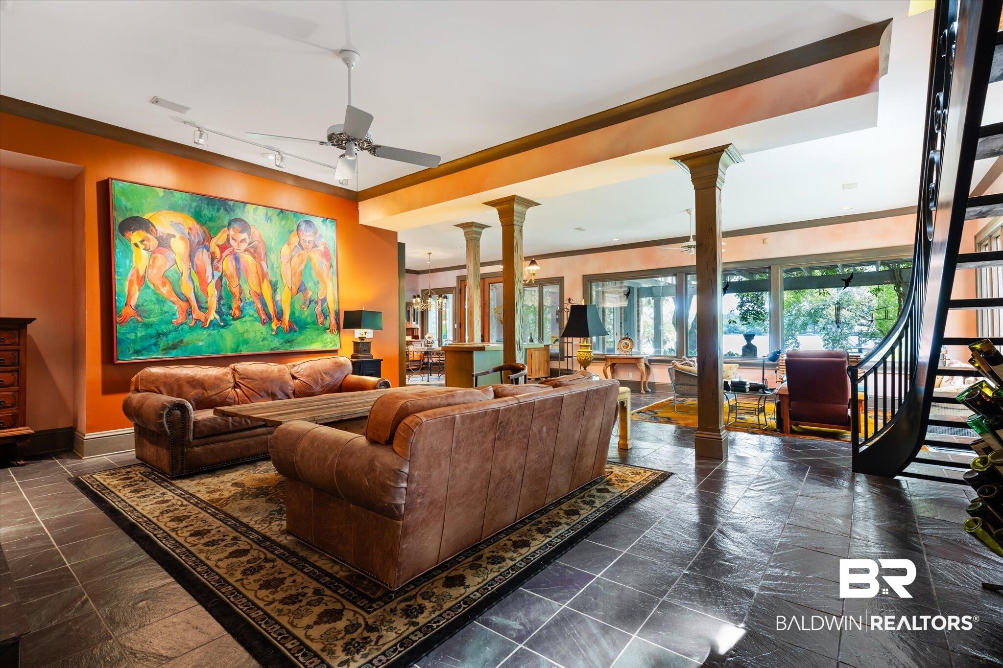 3325 Riviere Du Chien Road Mobile, AL 36693 - Photo 3 of 71 Living room featuring ceiling fan, track lighting, decorative columns, crown molding, and dark tile patterned floors