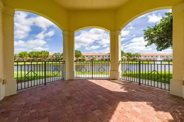 an aerial view of a house with a garden and lake view