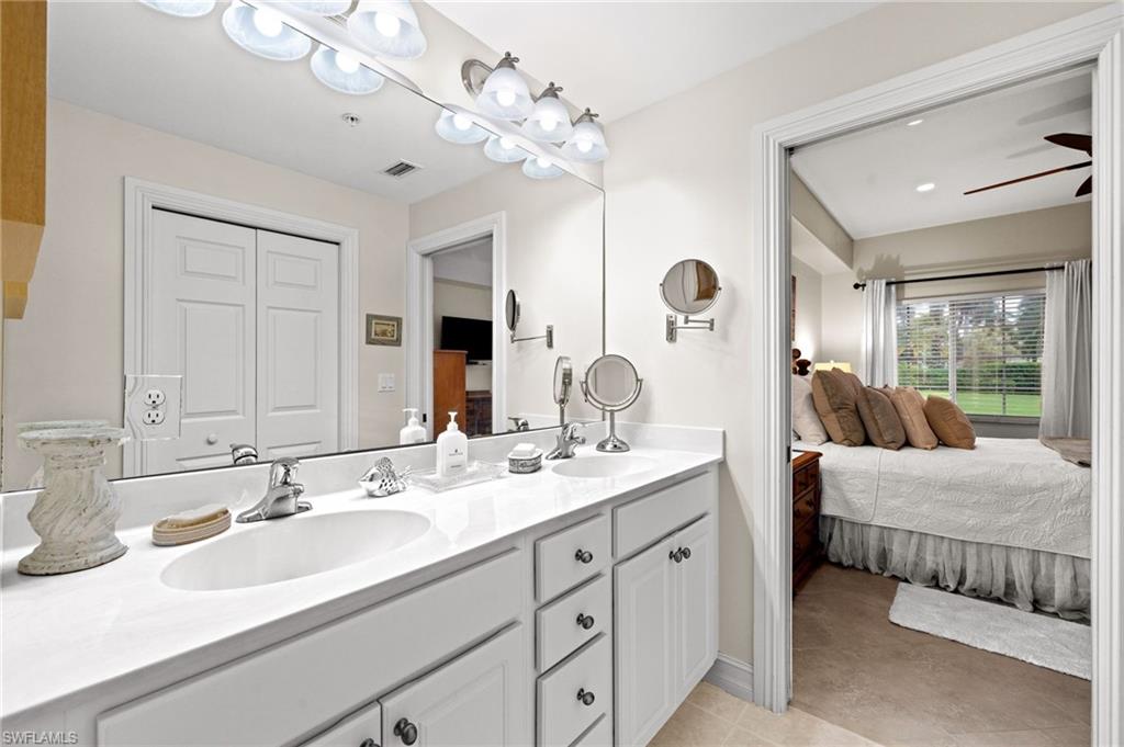 9128 Michael Circle, Unit 9 Naples, FL 34113 - Photo 13 of 50 Bathroom featuring ceiling fan, tile flooring, vanity with extensive cabinet space, and double sink