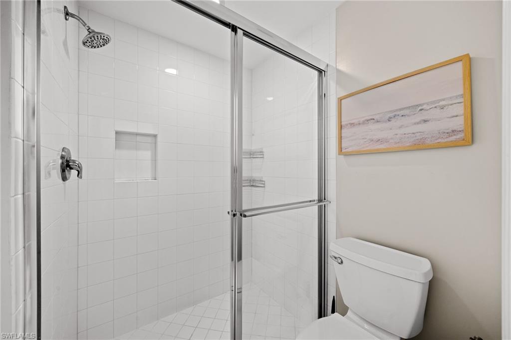 9128 Michael Circle, Unit 9 Naples, FL 34113 - Photo 14 of 50 Bathroom featuring an enclosed shower and toilet